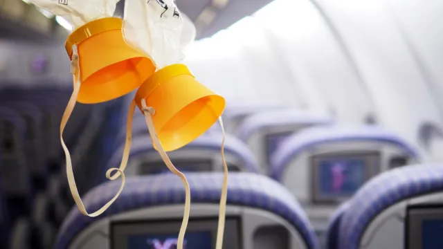 Cabin oxygen mask drop from the cabin ceiling.