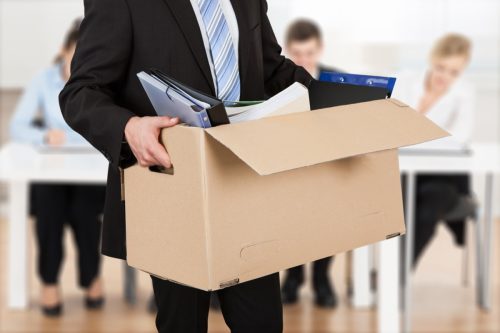 Close-up Of A Businessperson Carrying Cardboard Box During Office Meeting