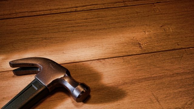 Carpenter,Claw,Hammer,Tool,On,Oak,Wood,Workbench,Boards,In