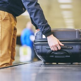 Man Puts Camera on Suitcase in Airport