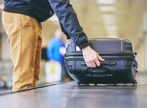 Man Puts Camera on Suitcase in Airport