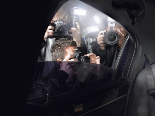 Paparazzi taking pictures through car window