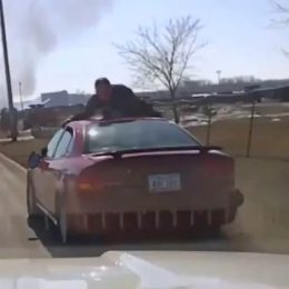 Officer Clings to Roof of Car During Wild Police Chase