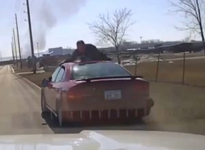 Officer Clings to Roof of Car During Wild Police Chase