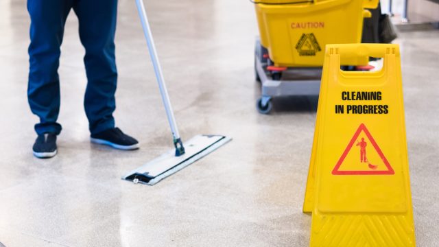 Janitor,Cleaning,Floor,In,Front,Of,Yellow,Caution,"cleaning,In