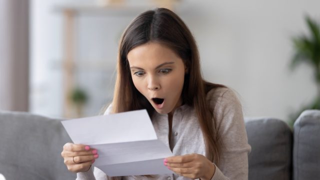 Amazed,Happy,Teen,Girl,Holding,Letter,Reading,Unbelievable,News,In