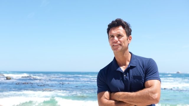 Portrait,Of,Rugged,Middle,Aged,Man,Standing,At,The,Beach
