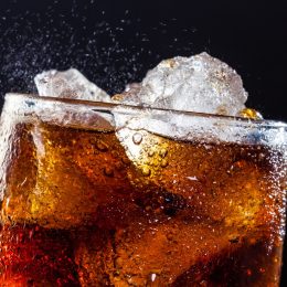 A cool glass of cola drink with ice, bubbles and fizz