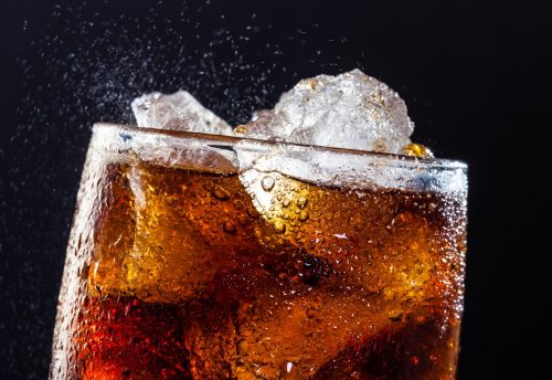 A cool glass of cola drink with ice, bubbles and fizz