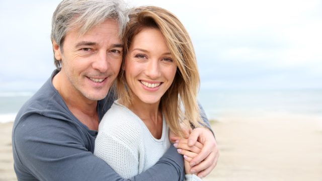 Cheerful,Mature,Couple,Embracing,By,The,Beach