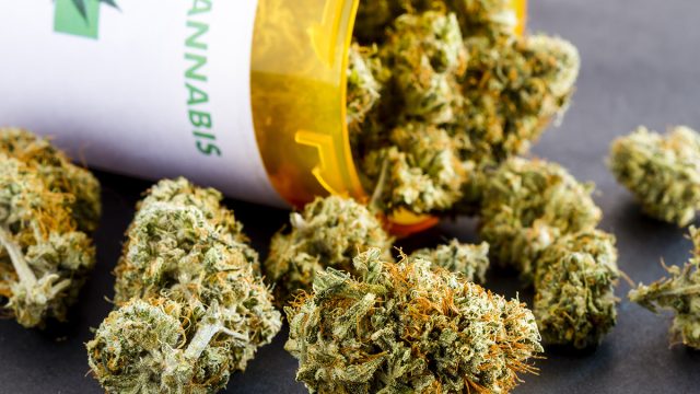 Close,Up,Of,Medical,Marijuana,Buds,Spilling,Out,Of,Prescription