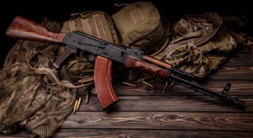 Classic Soviet AK machine gun on a wooden background. Weapons of Russia and the Soviet Union.
