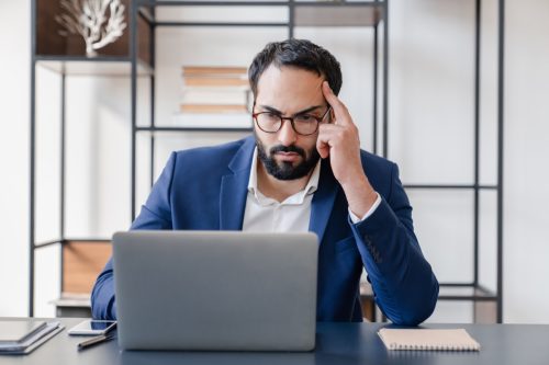 Tired concentrated hard-working businessman dealing with job problems, failure, troubles with occupation