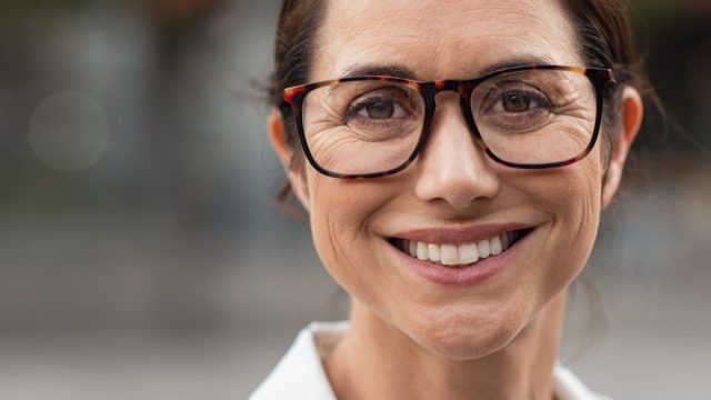 Portrait of mature businesswoman wearing eyeglasses and looking at camera.