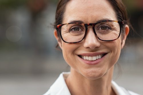 Portrait of mature businesswoman wearing eyeglasses and looking at camera.