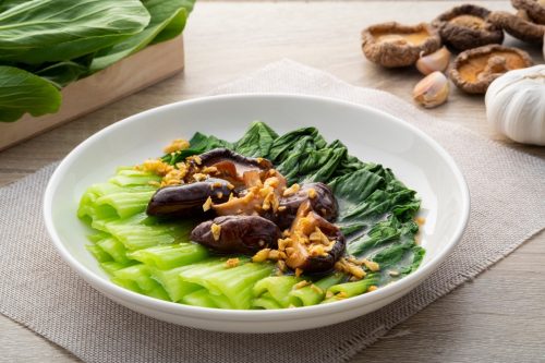 Baby Bok choy or chinese cabbage in mushroom vegetarian sauce with Shitake Mushrooms and fried garlic