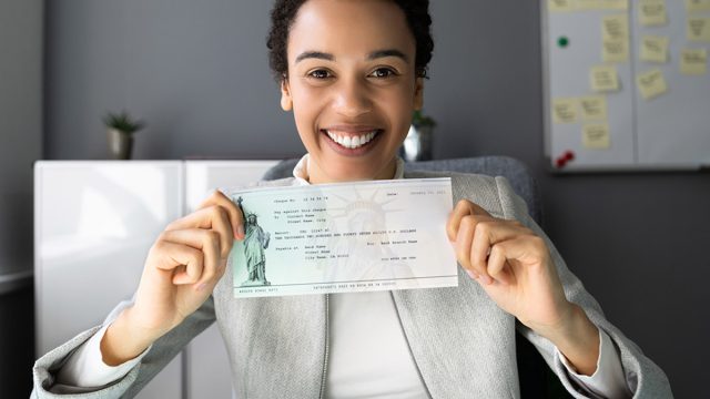 Stimulus check, Women,Holding,Payroll,Cheque,Or,Money,Check