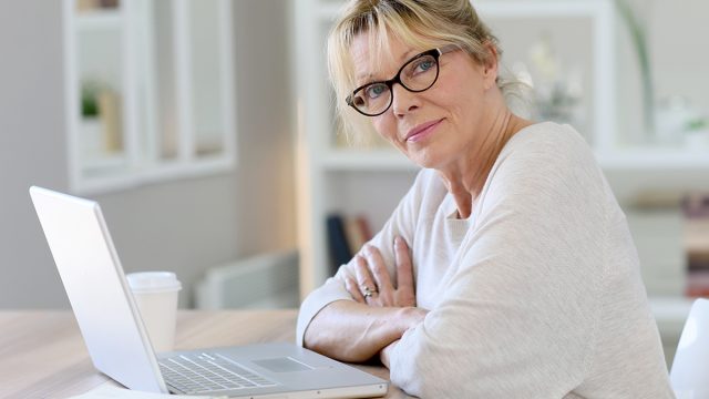 Portrait,Of,Senior,Woman,Working,On,Laptop,Computer