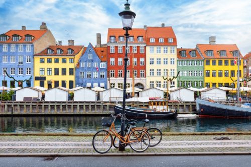The popular Nyhavn area at Copenhagen, Denmark, with a street light and bicycles in front of the colorful houses
