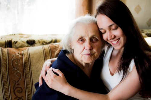 Grandmother and granddaughter hugging