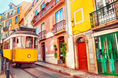 Yellow vintage tram on the street in Lisbon, Portugal. 