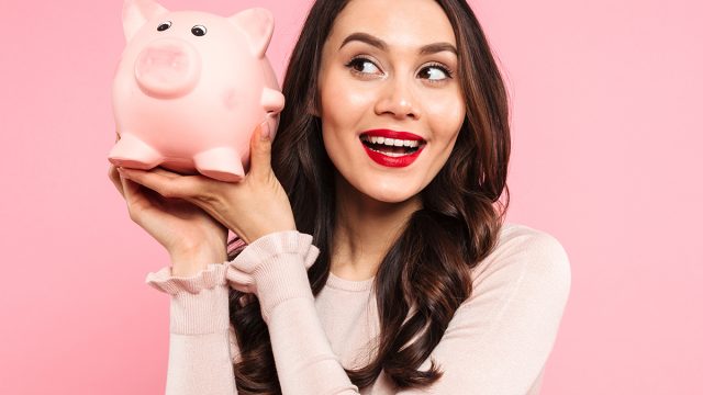 Saving money,Young,Woman,20s,In,Casual,Clothing,Holding,Piggybank,With