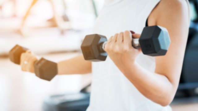 Blurred,Woman,Lifting,Dumbbells,In,Weight,Training,Fitness, ,Sport