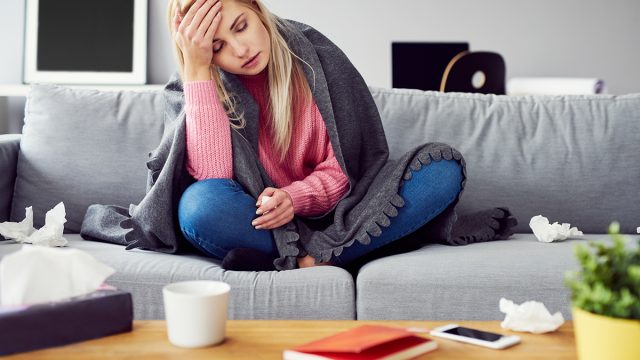 Sick,Woman,With,Headache,Sitting,Under,The,Blanket