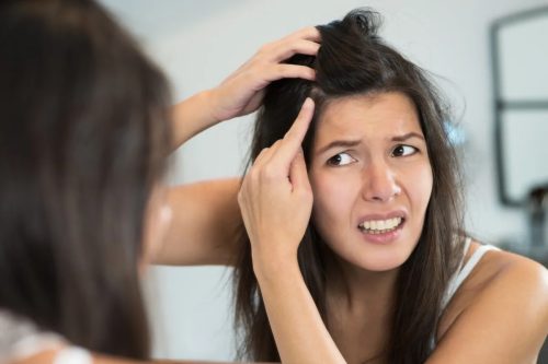 Woman looking into mirror.