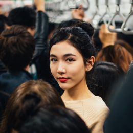 Asian woman in the crowded subway car.
