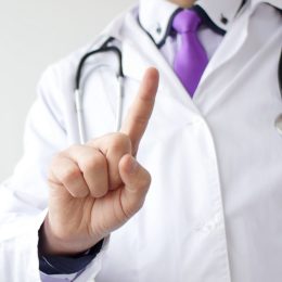 Medical doctor making negative sign for medicine by his finger.