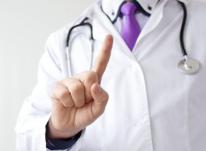 Medical doctor making negative sign for medicine by his finger.
