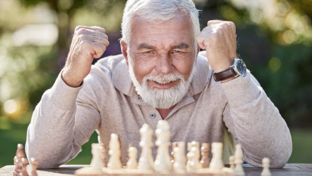 Senior, man ,playing ,chess, outside, cheering, old,happy