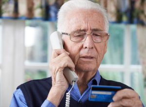 Senior Man Giving Credit Card Details On The Phone