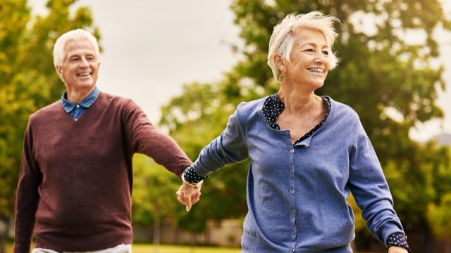 Love keeps a marriage alive. Shot of a happy senior couple going for a walk in the park.