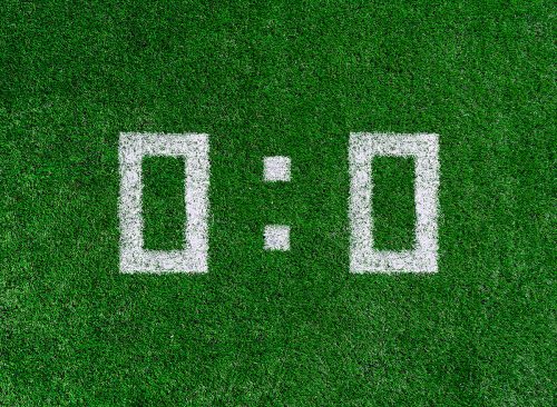 Football score 0:0.White numbers zero and zero are drawn on the green grass