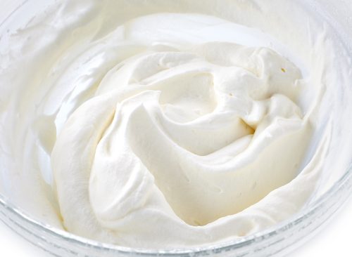 bowl of whipped cream on a white background