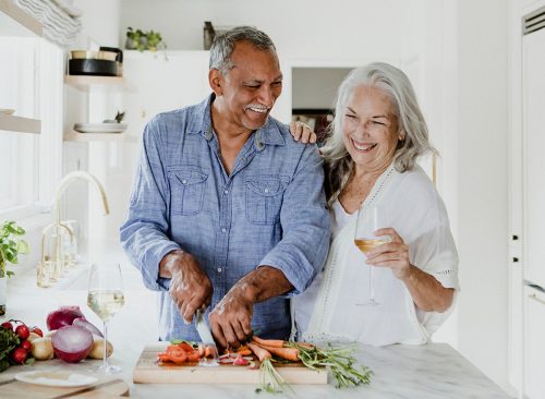 Elderly couple cooking in a kitchen