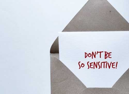 Craft envelope with handwritten message on copy space background - Don't Be So Sensitive, a gaslighting message to accuse or emotional abuse others to question their beliefs or doubt their perceptions