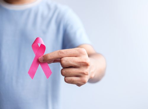 Pink October Breast Cancer Awareness month, man hold pink Ribbon for support people life and illness. National cancer survivors month, Mother and World cancer day concept