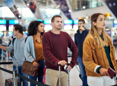 Travel, queue and wait with man in airport for vacation, international trip and tourism. Holiday, luggage and customs with passenger in line for airline ticket, departure and flight transportation