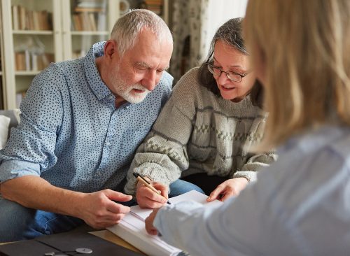 Senior couple signs a contract or power of attorney or fills out an application