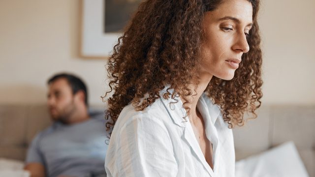 Upset, bedroom and woman in argument with her husband for divorce, marriage problem or breakup. Sad, depression and female person fighting with her partner for toxic relationship or cheating at home.