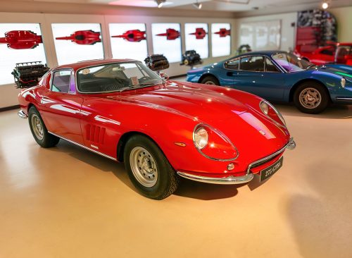 MODENA, ITALY - JULY 23, 2012: Museum Enzo Ferrari Modena. Red Ferrari 275 GTB 4 1966 with Ferrari horse, symbol of Ferrari on hood