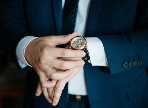 businessman looking at his watch on his hand, watching the time