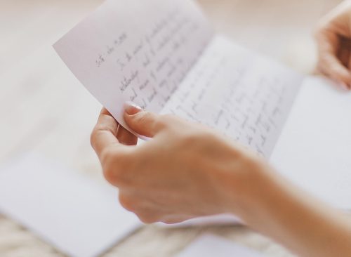 Hands of young woman holding handwritten letter