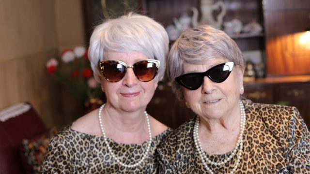 Senior sisters with matching leopard outfits